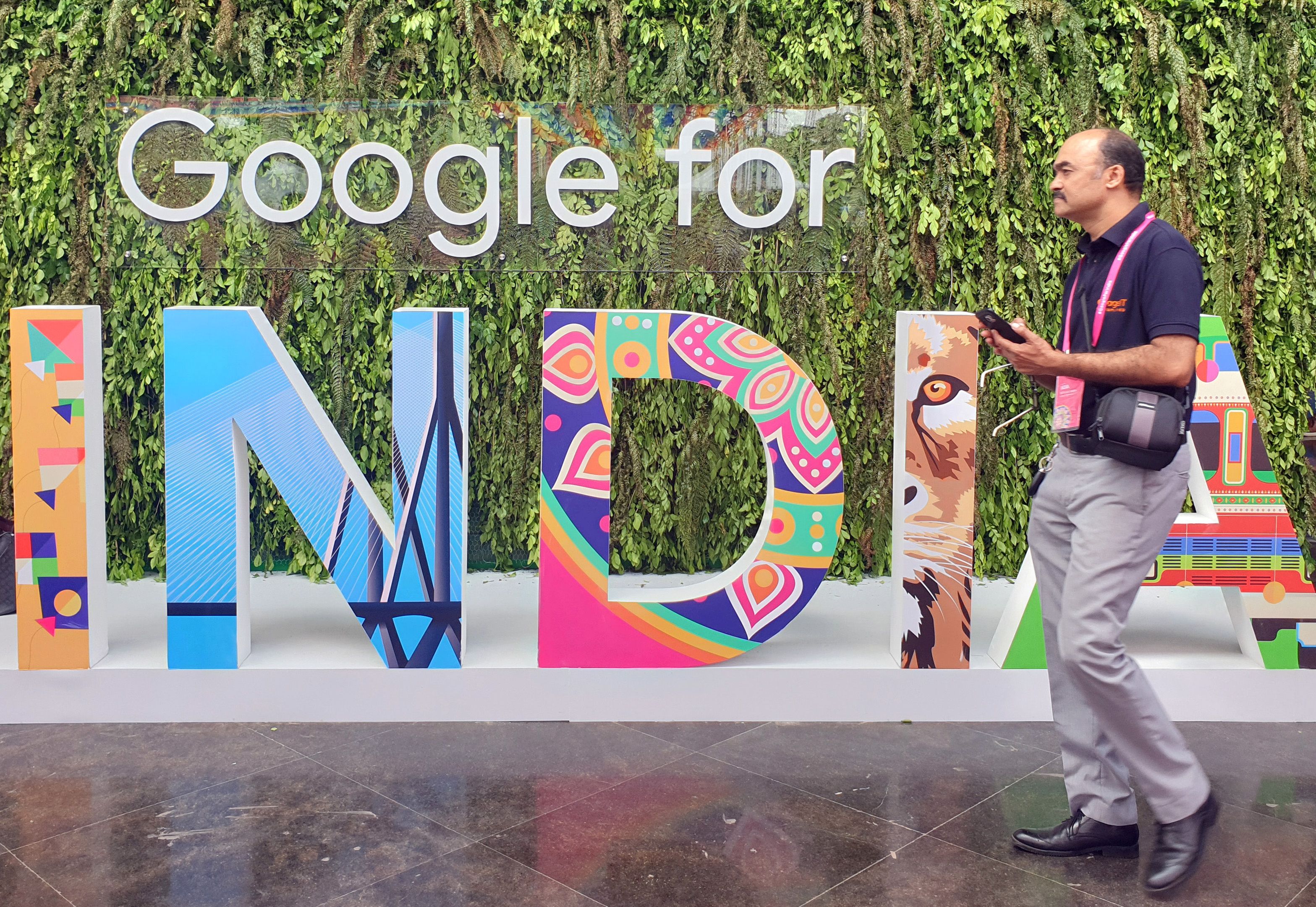 A man walks past the sign of "Google for India", the company's annual technology event in New Delhi, India