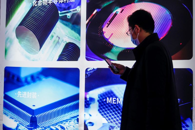 A man looks at a semiconductor display at a trade fair in Shanghai