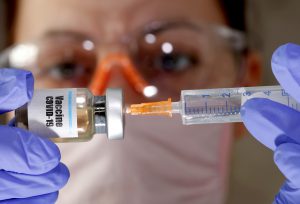 Vaccine setback, virus spike spooks markets
