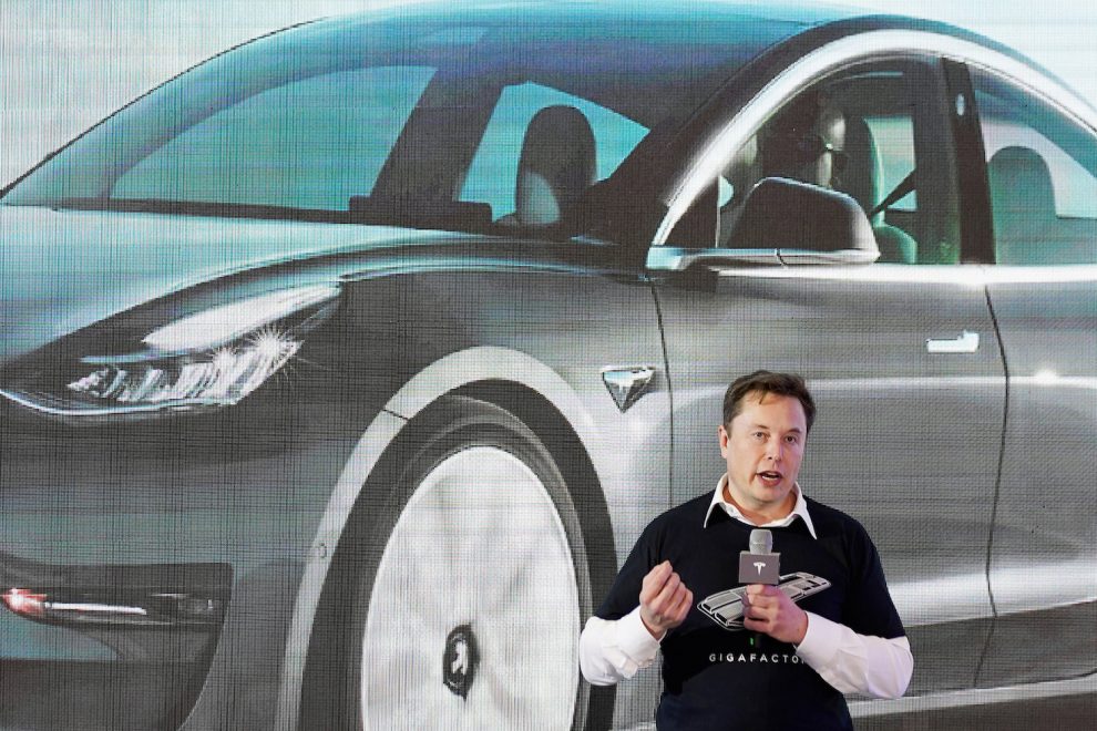 Elon Musk and a Tesla EV car