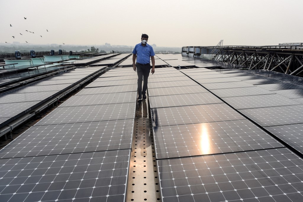 A man walks on solar panels