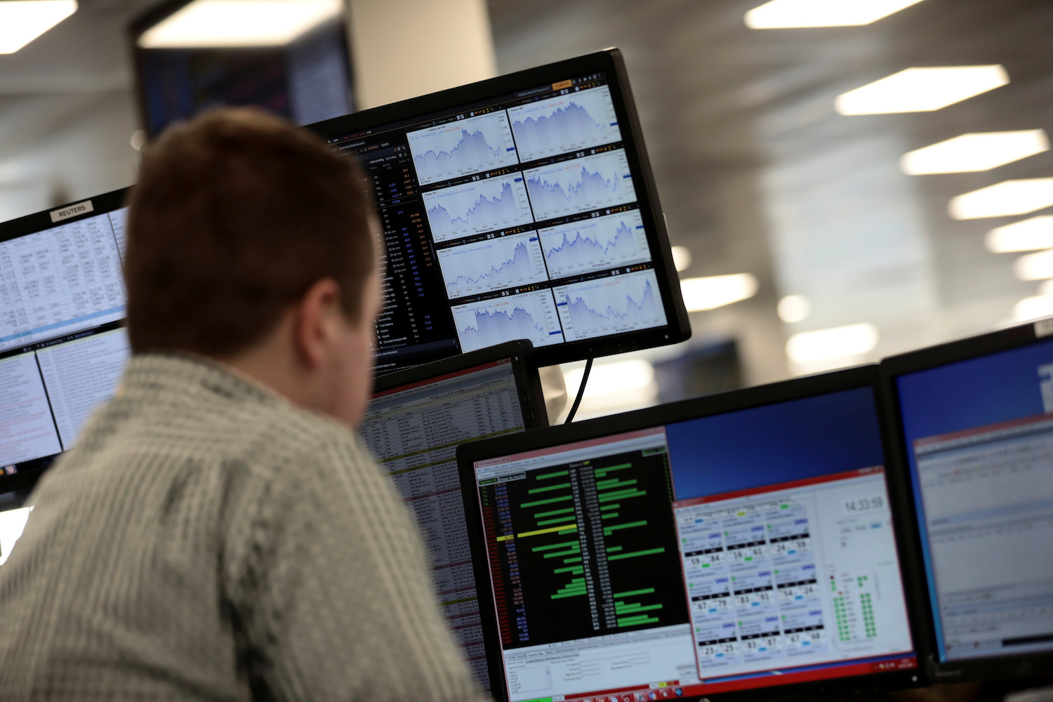 Traders check market screens