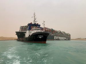 Tugboats try to shift huge container vessel blocking Suez Canal