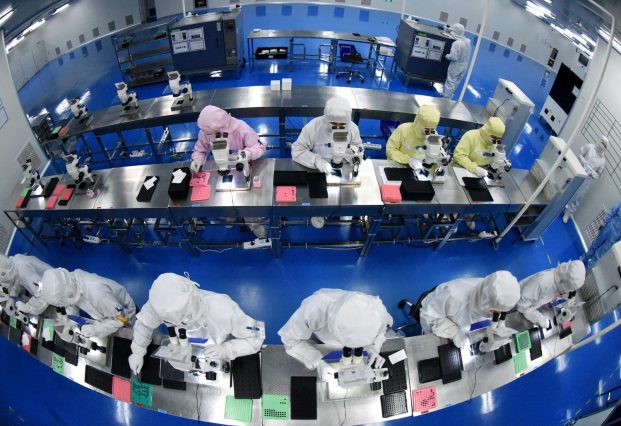 Chinese employees work on a production line. Chinese government support is seen to exceed most other major economies.