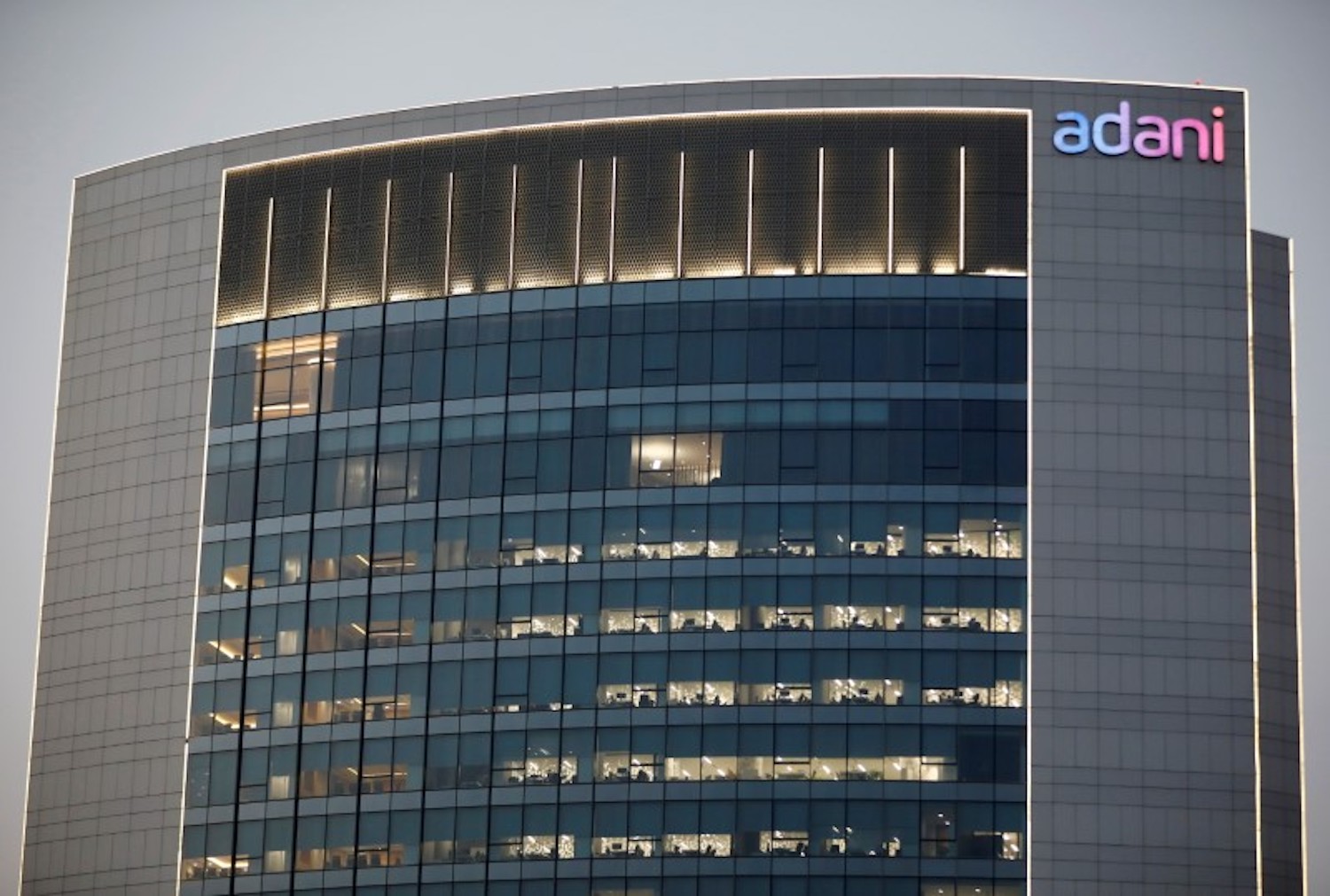 The logo of the Adani Group is seen on the facade of one of its buildings on the outskirts of Ahmedabad, India