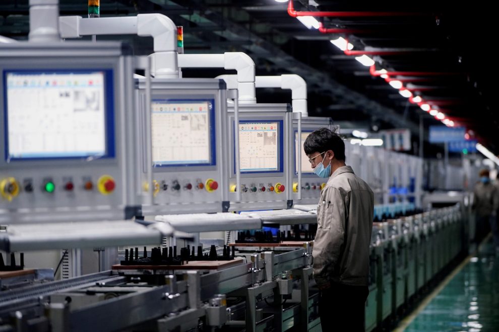 An employee works on the production line of electric vehicle battery manufacturer Octillion in Hefei, Anhui province