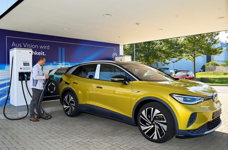 An employee presents the Volkswagen model EV ID. 4 during a media show in Zwickau, Germany. It plans to introduce the car in the China EV market