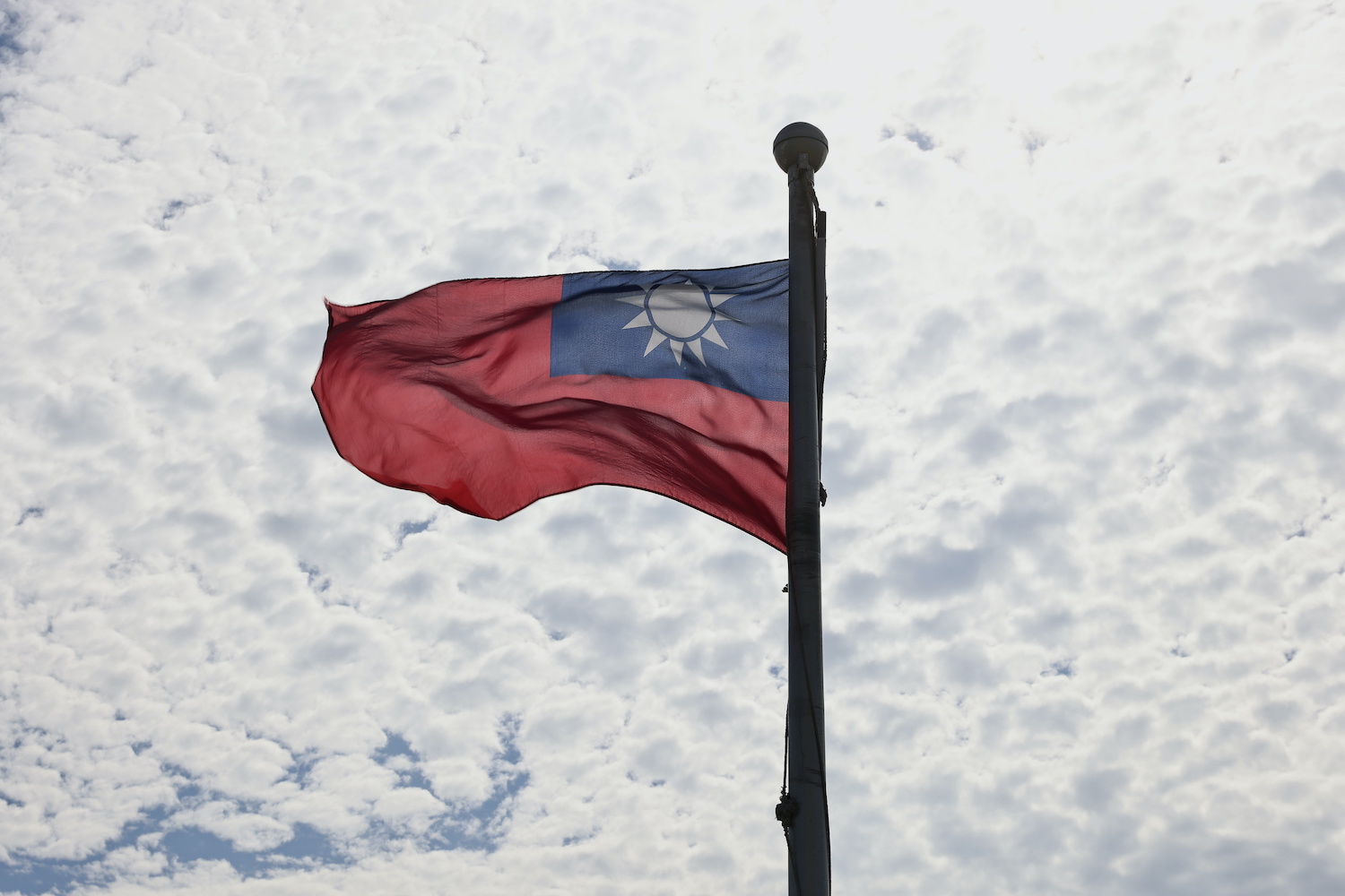 Taiwan's flag flies as its firms are warned by Beijing