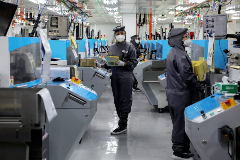 People work at the at the chip packaging firm Unisem's plant in Ipoh