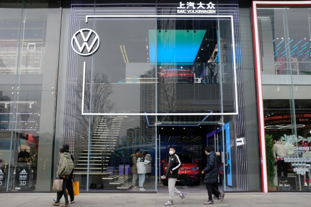 People inspect a Volkswagen ID.4X EV in a showroom in Chengdu in China's Sichuan province