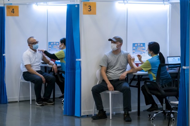 China will roll out more booster shots this week, Global Times says, while some citizens are flying to Macao to get an mRNA vaccine.