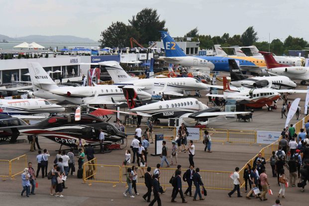 Helicopters and private jets are exhibited during the Singapore Airshow on February 7, 2018. The Singapore Airshow, Asia's largest aerospace and defence event, takes place from February 6 to 11. ROSLAN RAHMAN / AFP