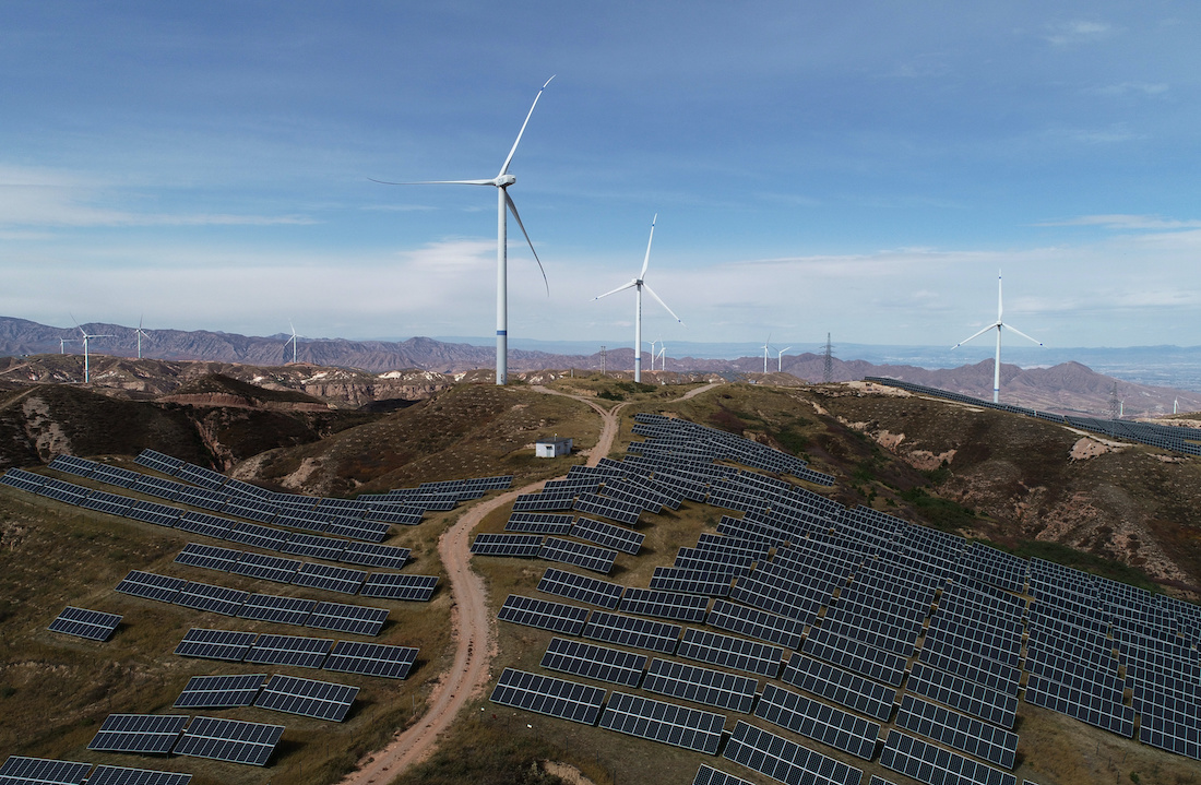 Wind turbines and solar panels are seen at a wind and solar power plant by State Power Investment Corporation (SPIC) in Zhangjiakou, Hebei province, China