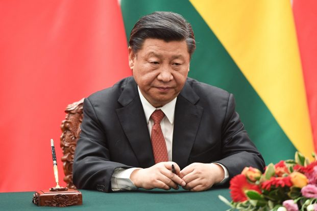 Chinese President Xi Jinping waits for his documents during a signing ceremony with Bolivia's President Evo Morales (not pictured) at the Great Hall of the People in Beijing on June 19, 2018. GREG BAKER / POOL / AFP