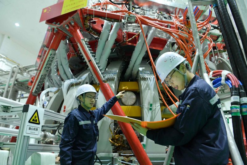 Technical personnel checks the China’s HL-2M nuclear fusion device, known as the new generation of "artificial sun", at a research laboratory in Chengdu, in eastern China's Sichuan province on December 4, 2020. China successfully powered its "artificial sun" nuclear fusion reactor for the first time, state media reported on December 4, marking a great advance in the country's nuclear power research capabilities. STR / AFP