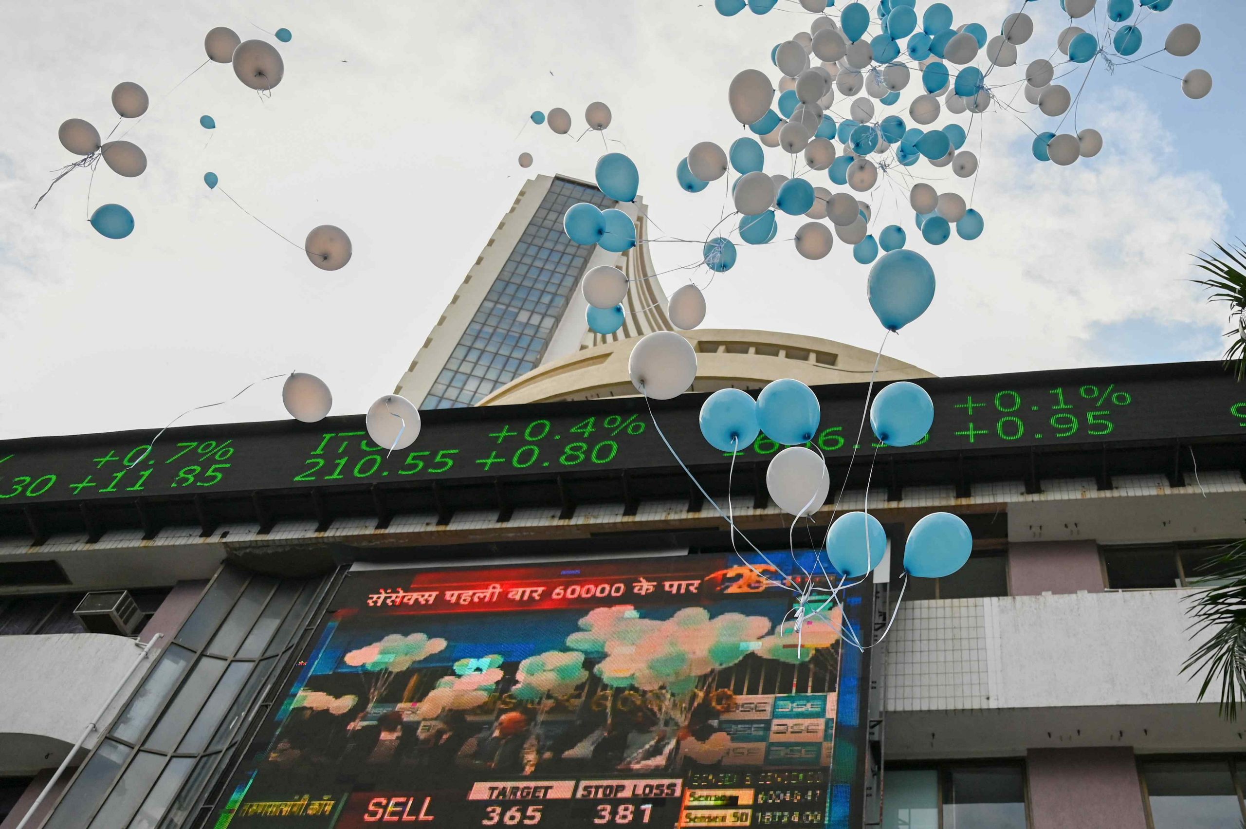 Balloons are released at the entrance of the Bombay Stock Exchange (BSE) to celebrate the benchmark of the Sensex index, which climbed above 60,000 points, in Mumbai on September 24, 2021. Punit PARANJPE / AFP