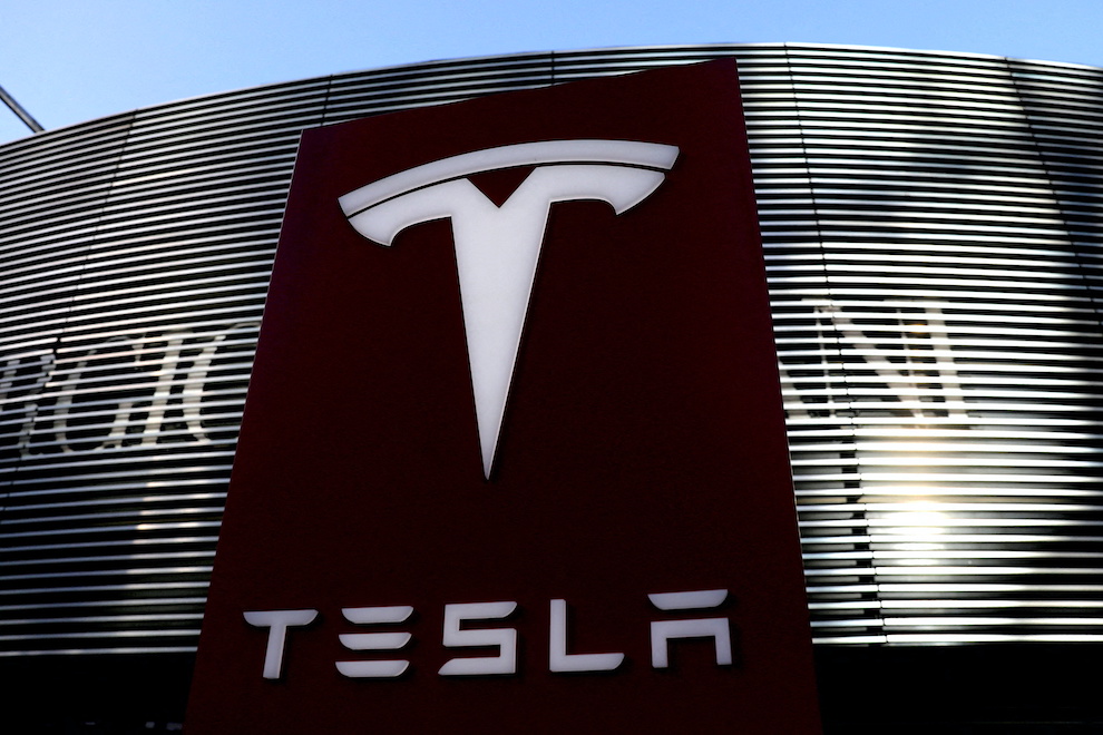 A logo of the electric-vehicle maker Tesla is seen near a shopping complex in Beijing, China January 5, 2021. REUTERS/Tingshu Wang/File Photo