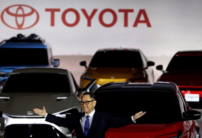 Japan changed a key policy document to put hybrid vehicles on par with battery-electric cars after a Toyota head threatened the government.