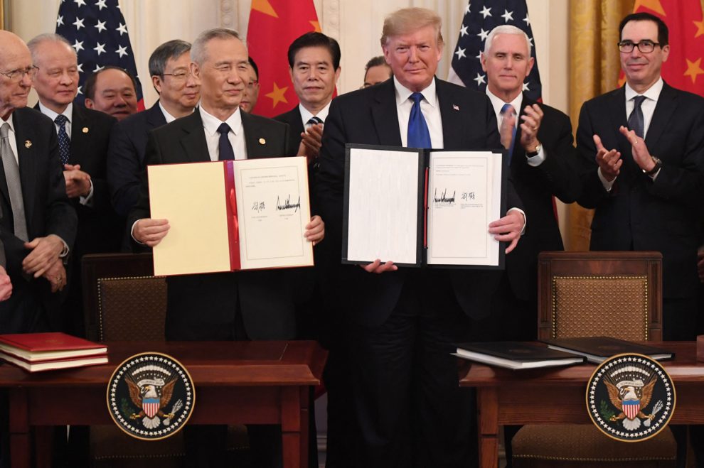 Chinese Vice Premier Liu He and US President Donald Trump sign a trade agreement between the US and China in the East Room of the White House in Washington, DC, January 15, 2020.