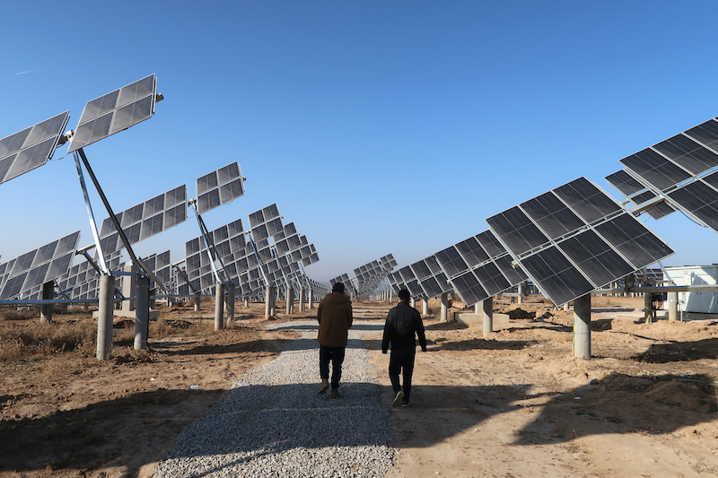 Workers at a solar power station in Tongchuan, Shaanxi province, China