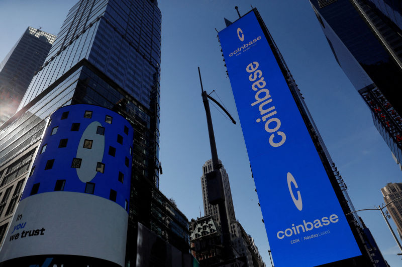 The logo for Coinbase Global Inc is displayed on the Nasdaq MarketSite jumbotron and others at Times Square in New York