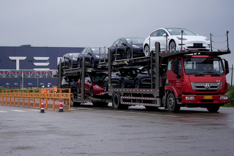 A truck transports new Tesla cars from its factory in Shanghai, May 13, 2021. Photo: Aly Song, Reuters.