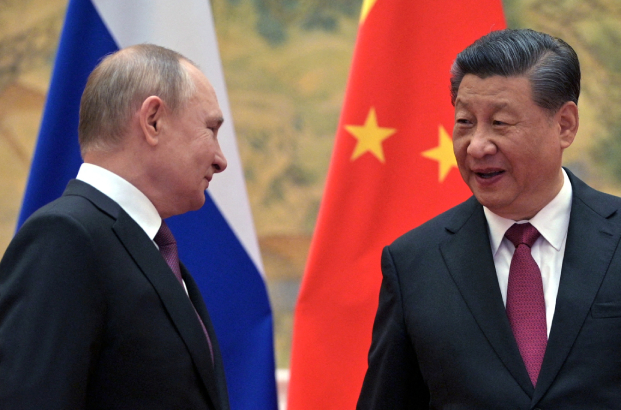 Russian President Vladimir Putin talks with Chinese President Xi Jinping in Beijing