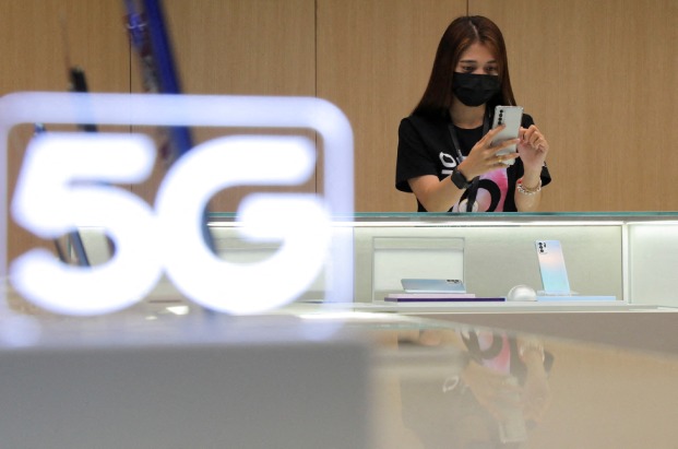 Malaysia's 5G rollout has been delayed by telecom firms not wanting to join a state-run 5G agency, sources say.