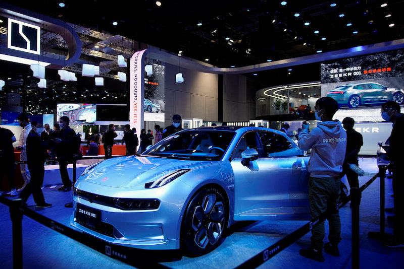 Visitors look at a Geely-made Zeekr 001 electric vehicle at the Auto Shanghai show in April 2021