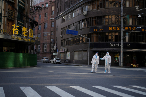 Workers in protective suits during a lockdown in Shanghai.