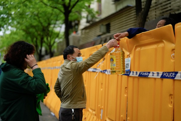 People pass edible oil over the barriers