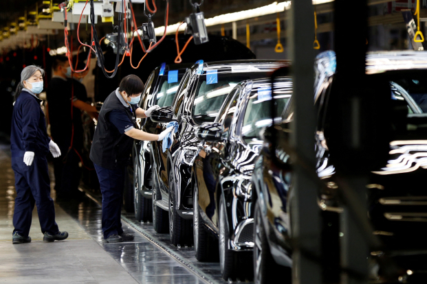 Chinese employees work on the production line