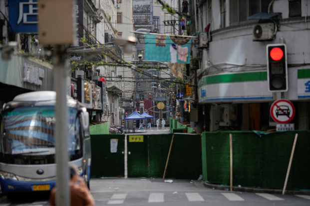 Workers in protective suits are seen at a closed residential area during lockdown, amid the coronavirus disease (COVID-19) outbreak, in Shanghai, China,