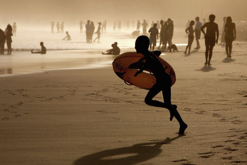 A boy plays at a beach on Hainan Island, but spending was down over China's Golden Week