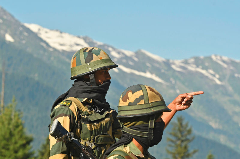 Indian soldiers guard a highway leading towards Leh