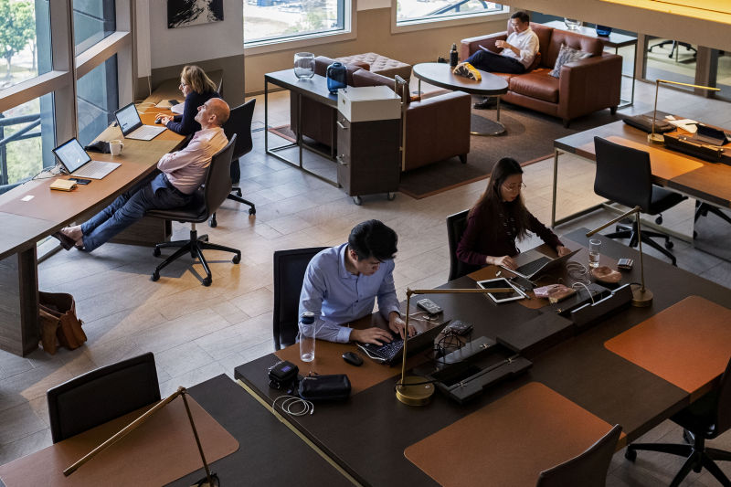 People sit at hot desks at The Great Room's co-working space in Singapore