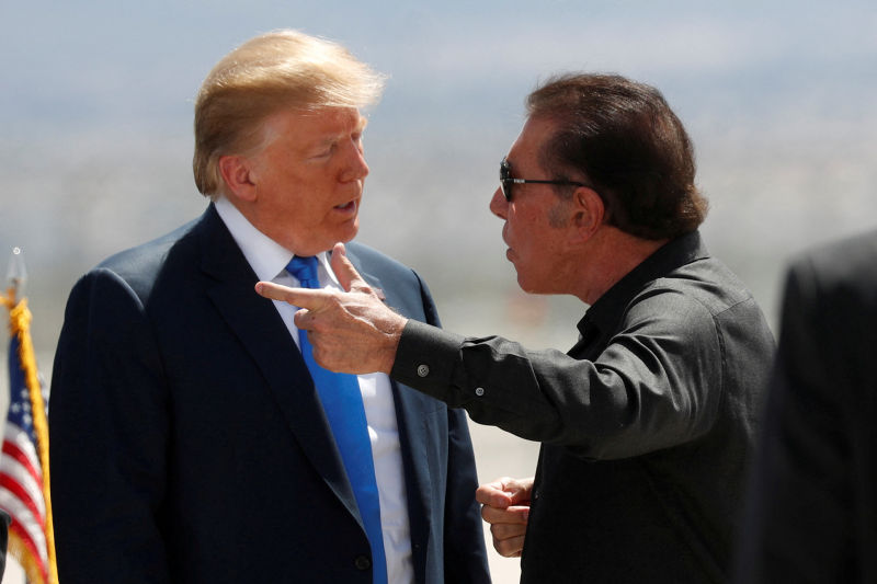Casino tycoon Steve Wynn, seen here talking to former US president Donald Trump, has been accused of acting as an agent for China.