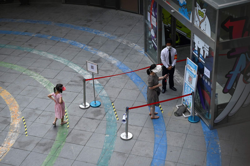 A Beijing resident uses her phone to scan the health code.