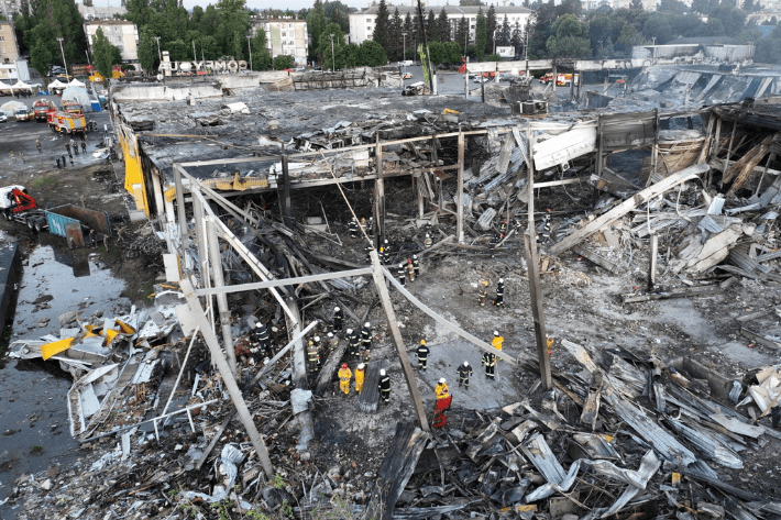 Rescuers work at a site of a shopping mall hit by a Russian missile strike in Kremenchuk, Ukraine
