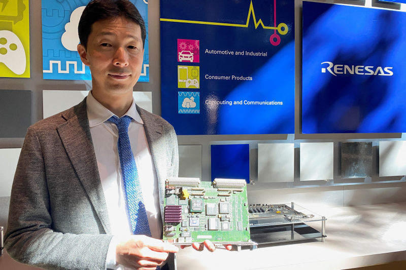 Hidetoshi Shibata, the chief executive of Renesas, displays a printed circuit board at the company's San Jose office