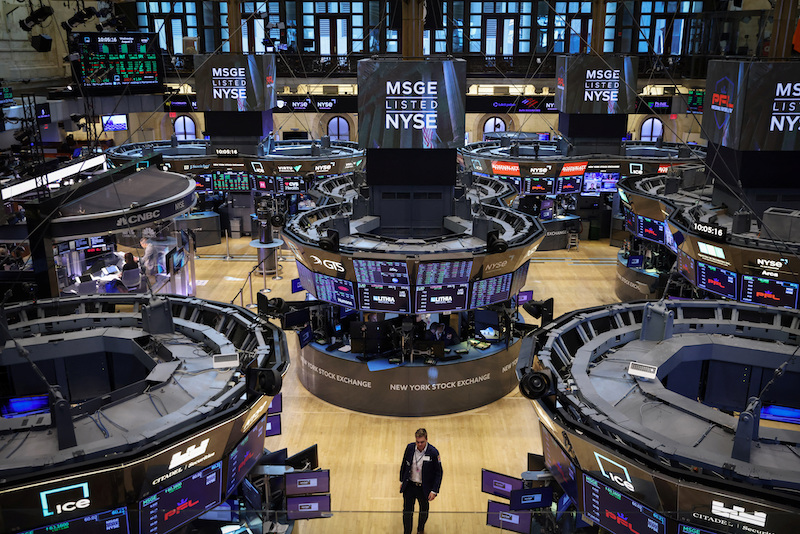 A trader walks on the trading floor at the New York Stock Exchange (NYSE) in Manhattan, New York City