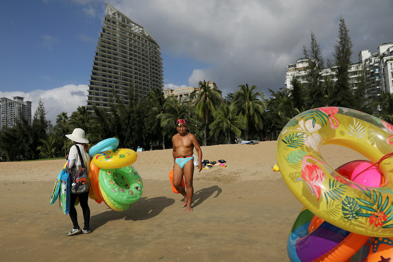 Over 80,000 tourists are stuck in Sanya beach resort, a report said on Sunday.