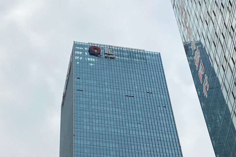 A partially removed company logo of China Evergrande Group is seen on the facade of its headquarters in Shenzhen, Guangdong province