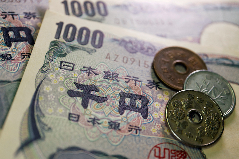 Coins and Japanese yen banknotes are seen in this image