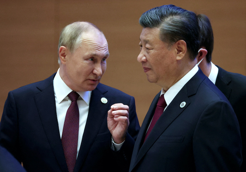 Russian President Vladimir Putin speaks with Chinese leader Xi Jinping before a Shanghai Cooperation Organization meeting in Samarkand, Uzbekistan