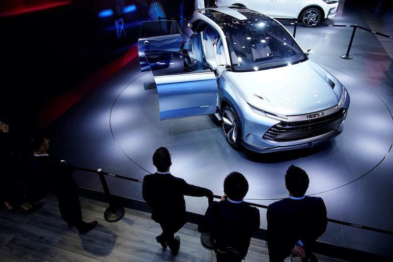 People stand near a BYD X Dream electric vehicle (EV) displayed during a media day for the Auto Shanghai show in Shanghai, China April 19, 2021. REUTERS/Aly Song/File Photo