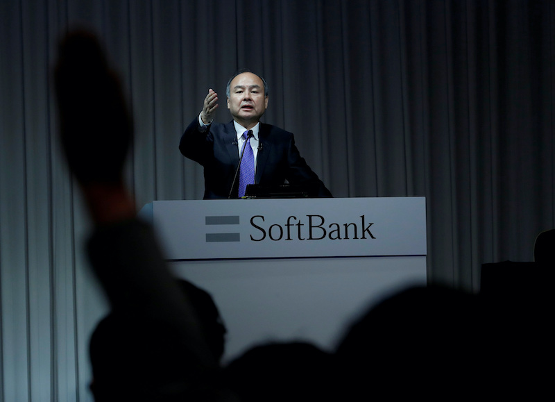 A journalist raises her hand to ask a question to Japan's SoftBank Group Corp Chief Executive Masayoshi Son during a news conference in Tokyo, Japan