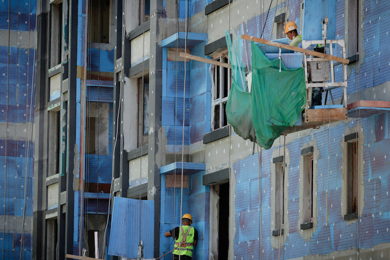 Men working at a construction site of apartment buildings in Beijing, on July 15, 2022. Photo: Reuters