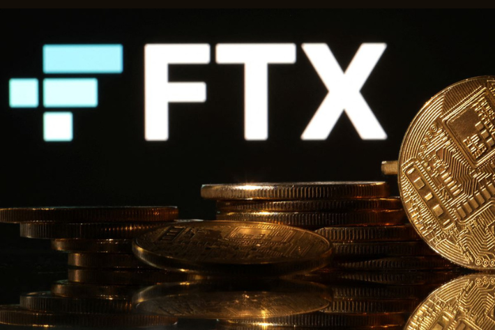 Representations of cryptocurrencies are seen in front of displayed FTX logo in this illustration