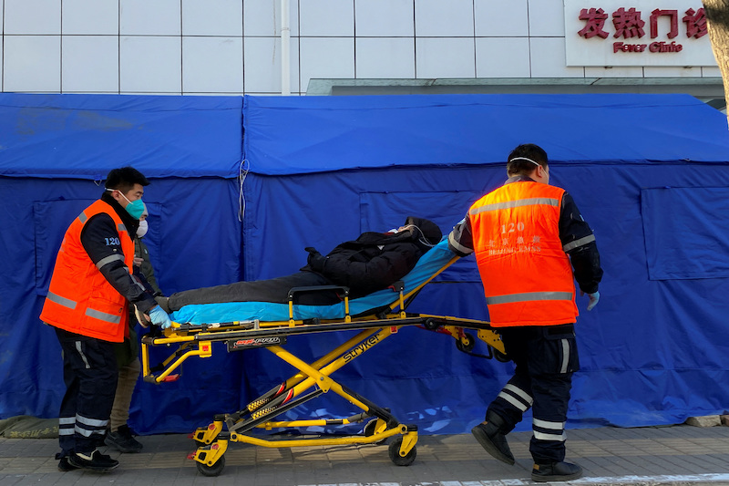 Medics move a patient into a fever clinic at a hospital as coronavirus disease (COVID-19) outbreaks continue in Beijing